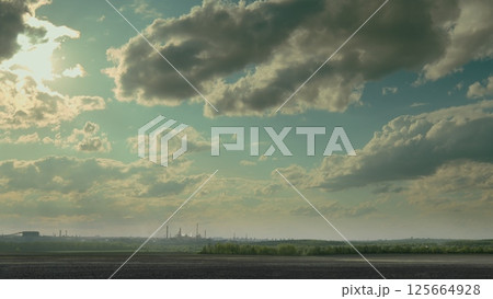 A Stunning and Beautiful Landscape Featuring Clouds Against a Vast Industrial Background A Stunning and Beautiful Landscape Featuring Clouds Against a Vast Industrial Background 125664928