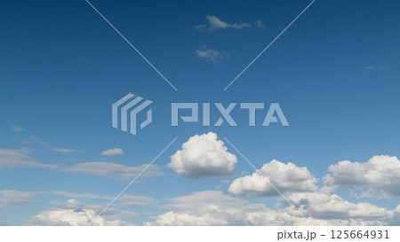 A Beautiful Blue Sky with Fluffy White Clouds Enhancing the Scenic Atmosphere Above 125664931