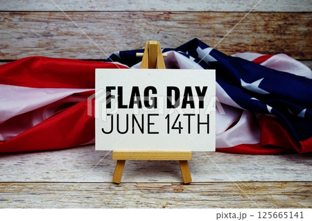 Happy Flag Day text message with USA flag on wooden background, America national holiday concept 125665141