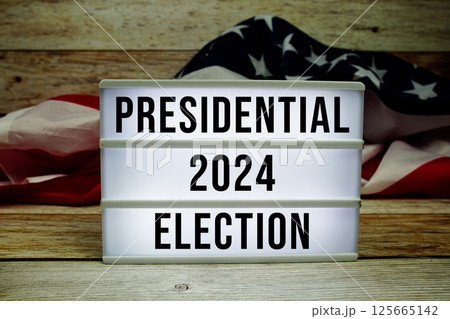 Vote 2024, Presidential Election with USA American flag on wooden background 125665142