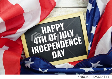 Happy Forth of July Independence Day text message  with USA flag on wooden background, America national holiday concept 125665144