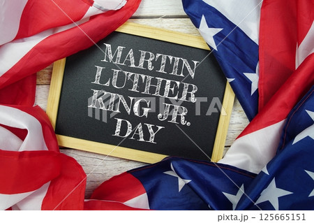Happy Martin Luther King Jr Day text message with USA flag on wooden background, America national holiday concept 125665151