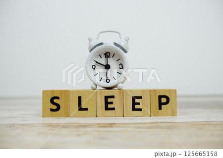 Time to Sleep with wooden blocks alphabet letters and alarm clock on wooden background Time to Sleep with wooden blocks alphabet letters and alarm clock on wooden background 125665158