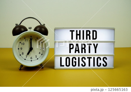 Third-party Logistics text on light box with alarm clock on yellow background 125665163