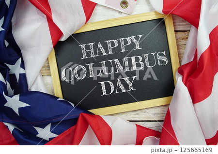 Happy Columbus Day text message with USA flag on wooden background, America national holiday concept Happy Columbus Day text message with USA flag on wooden background, America national holiday concept 125665169