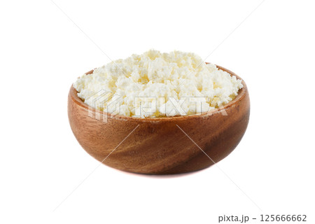 Wooden bowl full of fresh cottage cheese on white background. Wooden bowl full of fresh cottage cheese on white background. 125666662