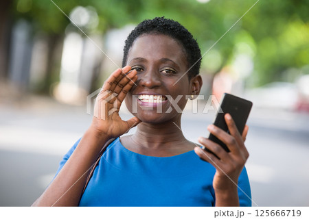 Close-up of young girl with mobile phone, happy. 125666719