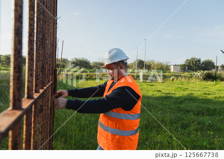 Worker Measuring The Iron Door  125667738