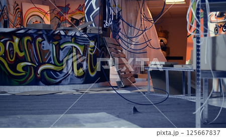 Empty derelict underground warehouse interior used by trespassing urban explorers venturing into abandoned structures. Graffiti art and scattered debris in urbex location with nobody in Empty derelict underground warehouse interior used by trespassing urban explorers venturing into abandoned structures. Graffiti art and scattered debris in urbex location with nobody in 125667837