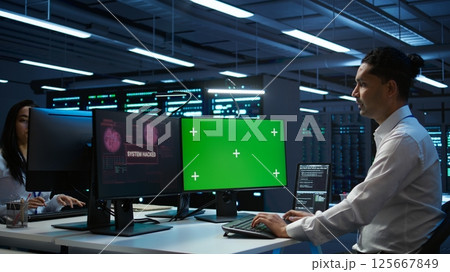 System administrator using AI tech on isolated screen PC to do maintenance in server room. Skilled expert in data center using artificial intelligence on chroma key to process datasets for training System administrator using AI tech on isolated screen PC to do maintenance in server room. Skilled expert in data center using artificial intelligence on chroma key to process datasets for training 125667849