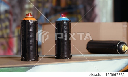 Close up of spray cans left over in underground ghetto by urban explorers venturing into abandoned structures. Graffiti paint cans and scattered debris in urbex location with nobody in, panning shot Close up of spray cans left over in underground ghetto by urban explorers venturing into abandoned structures. Graffiti paint cans and scattered debris in urbex location with nobody in, panning shot 125667882