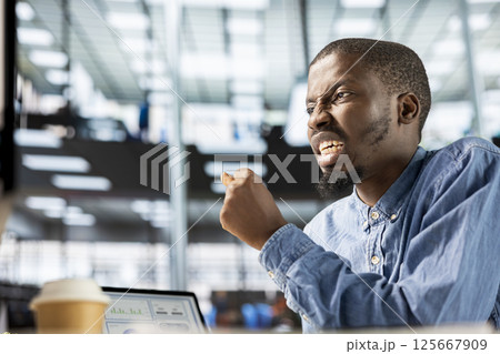 General manager sits at his computer frustrated and overwhelmed by the workload of business tasks. Entrepreneur dealing with fatigue after experiencing pressure at the workplace. General manager sits at his computer frustrated and overwhelmed by the workload of business tasks. Entrepreneur dealing with fatigue after experiencing pressure at the workplace. 125667909