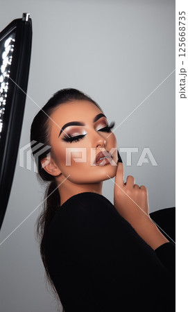 Glamour portrait featuring makeup beauty, cosmetics, and fashion style in an elegant studio 125668735