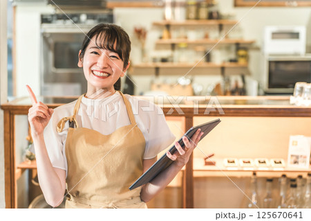 タブレットで注文を確認するレストランスタッフ(アルバイト,バイト,ウェイトレス) タブレットで注文を確認するレストランスタッフ(アルバイト,バイト,ウェイトレス) 125670641
