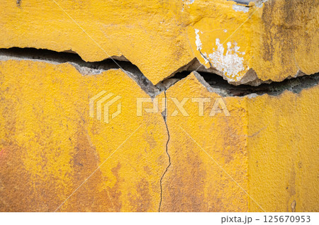 Full frame shot of cracked wall. Wider cracks often represent serious structural damage and can cause serious issues. Full frame shot of cracked wall. Wider cracks often represent serious structural damage and can cause serious issues. 125670953