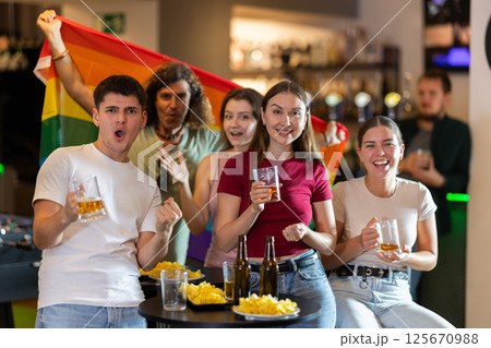 Group of fans in bar with LGBT flag Group of fans in bar with LGBT flag 125670988