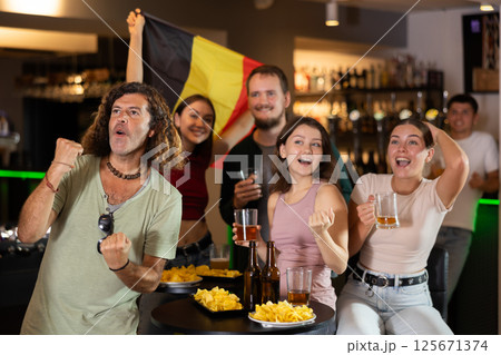 Group of fans in bar with Belgian flag Group of fans in bar with Belgian flag 125671374