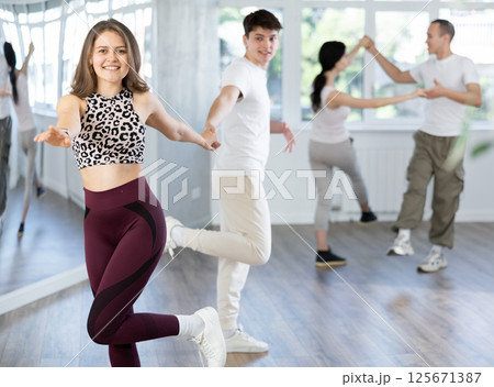 Girl paired up with young man, they train to perform disco fox dance, rehearse performance. Girl paired up with young man, they train to perform disco fox dance, rehearse performance. 125671387
