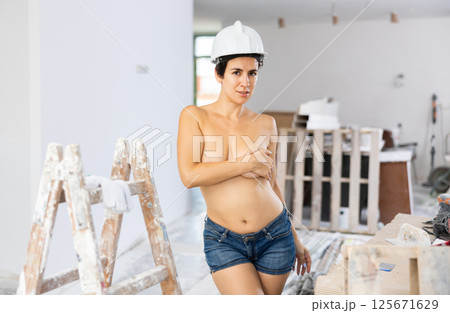 Sensual glamour sexy girl builder covering breast with hand 125671629