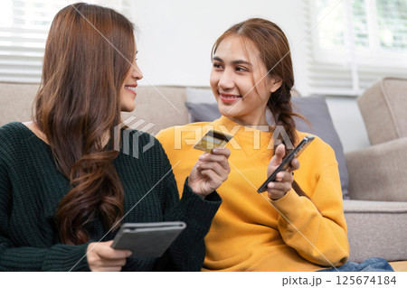 Online shopping journey: Friends discussing purchases joyfully Online shopping journey: Friends discussing purchases joyfully 125674184