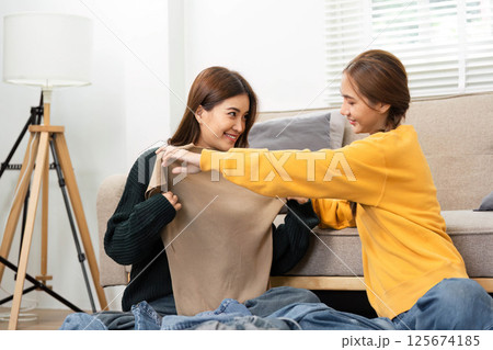 Travel Planning with Friends: Young Women Organizing Suitcase and Map 125674185