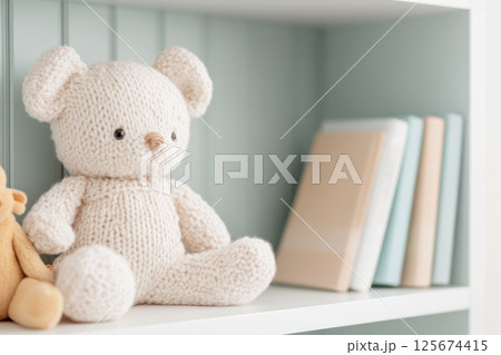 Cozy knitted plush bear sitting on shelf in nursery with books adding soft and serene atmosphere, AI Generative 125674415