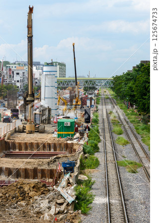 Bustling Elevated Railway Construction in Suburban Area. Bustling Elevated Railway Construction in Suburban Area. 125674733