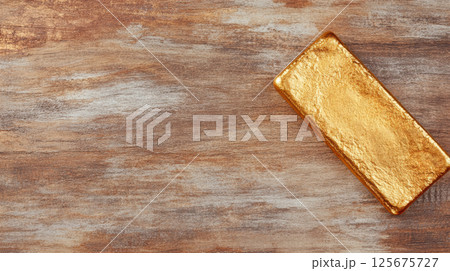 Solid gold bar on rustic wooden surface highlighting luxurious wealth and financial investment opportunities, AI Generative 125675727