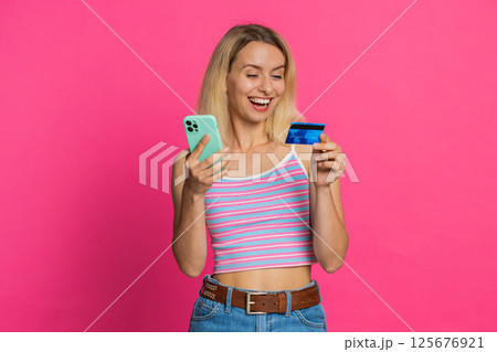 Woman use credit bank card smartphone while transferring spending money, purchases online shopping Woman use credit bank card smartphone while transferring spending money, purchases online shopping 125676921