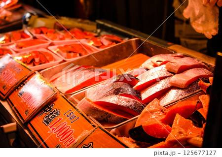 Slices of fresh salmon on display in a street food at ameyoko market, tokyo japan Slices of fresh salmon on display in a street food at ameyoko market, tokyo japan 125677127