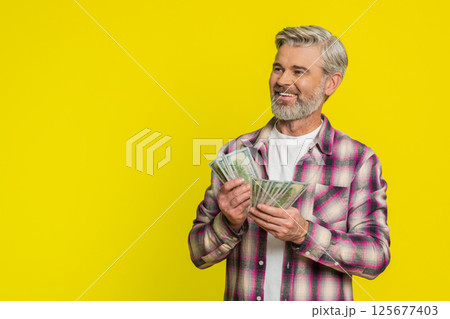 Mature man counting dollar money cash, satisfied smile, showing profit bonus wage financial success 125677403