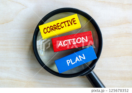 Corrective Action Plan text on colored wooden blocks with magnifying glass as background. Root cause analysis concept Corrective Action Plan text on colored wooden blocks with magnifying glass as background. Root cause analysis concept 125678352