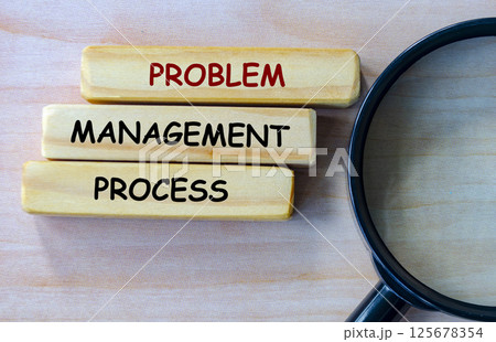 Top view of Problem Management Process text on wooden blocks with magnifying glass as background. Root cause analysis concept Top view of Problem Management Process text on wooden blocks with magnifying glass as background. Root cause analysis concept 125678354