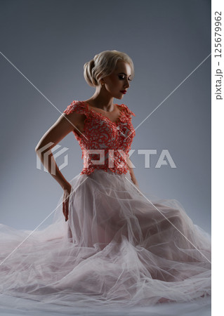 Bride in elegant dress poses dramatically with striking blood details 125679962