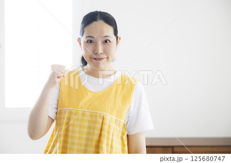 黄色いエプロンのミドル女性 125680747