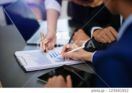 Team business meeting presentation. Hand businessman working project in modern office.Laptop computer and tablet and smart phone on white desk 125681922