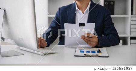 Business man working at office with laptop and documents on his desk new start up project. Finance task. 125681957