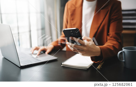 Businesswomen analyzing investment graph and discussing plan new start up project. Finance task. Businesswomen analyzing investment graph and discussing plan new start up project. Finance task. 125682061