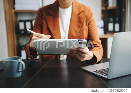 Businesswomen analyzing investment graph and discussing plan new start up project. Finance task. Businesswomen analyzing investment graph and discussing plan new start up project. Finance task. 125682065
