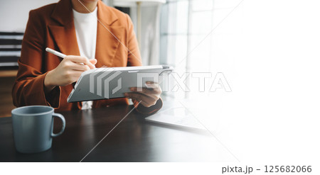 Businesswomen analyzing investment graph and discussing plan new start up project. Finance task. Businesswomen analyzing investment graph and discussing plan new start up project. Finance task. 125682066