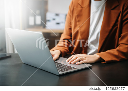 businesswoman hand working with new modern computer using on smartphone and tablet as concept 125682077