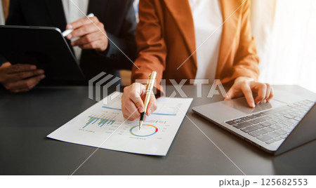 Business documents on office table with smart phone and calculator digital tablet and graph Business documents on office table with smart phone and calculator digital tablet and graph 125682553