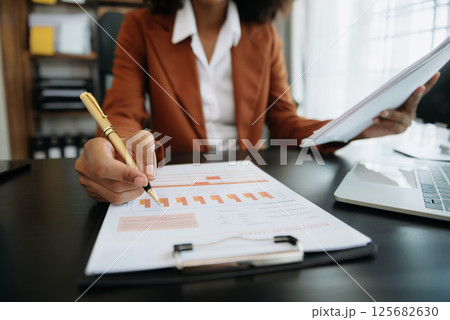 African businesswoman hand working with new modern computer using on smartphone and tablet as concept African businesswoman hand working with new modern computer using on smartphone and tablet as concept 125682630