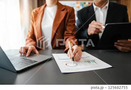 Business documents on office table with smart phone and calculator digital tablet and graph 125682755