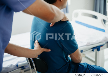 Doctor consulting with patient Back problems Physical on the bed in clinic concept Doctor consulting with patient Back problems Physical on the bed in clinic concept 125682758