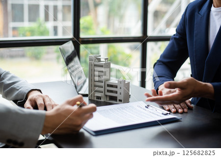 Sales giving male customer signing sales contract, Asian woman and man doing business in office, business concept and contract signing. 125682825