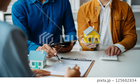 Considering buying a home, investing in real estate. Broker signs a sales agreement. agent, lease agreement, successful deal 125682834