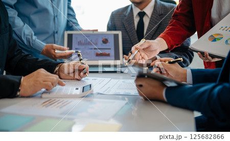 Team of business people working together in the meeting room office, teamwork background charts from financial document report, Office 125682866
