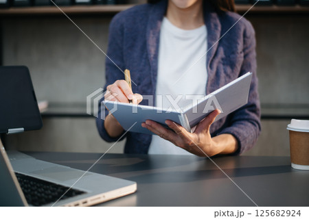 businesswoman hand working with new modern computer using on smartphone and tablet as concept 125682924