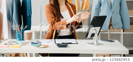 Young woman running online store Startup small business SME, using smartphone or tablet receive and checking online purchase shopping order Young woman running online store Startup small business SME, using smartphone or tablet receive and checking online purchase shopping order 125682953